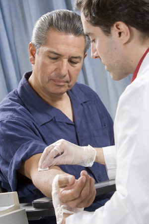 Man having his blood drawn by health care provider..